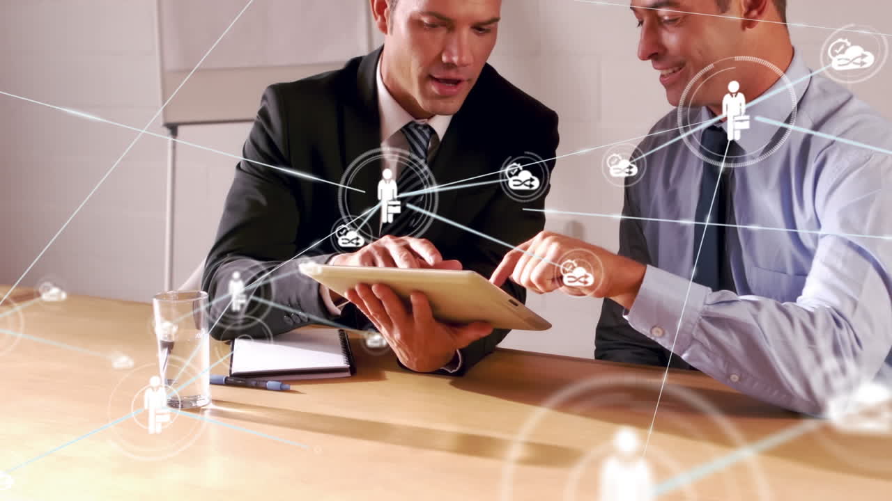Animation of network of digital icons over two diverse businessmen discussing at office