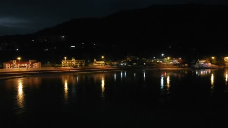 aerial shot of rishikesh city at night, ram jhula bridge situated on holy river ganga in rishikesh.