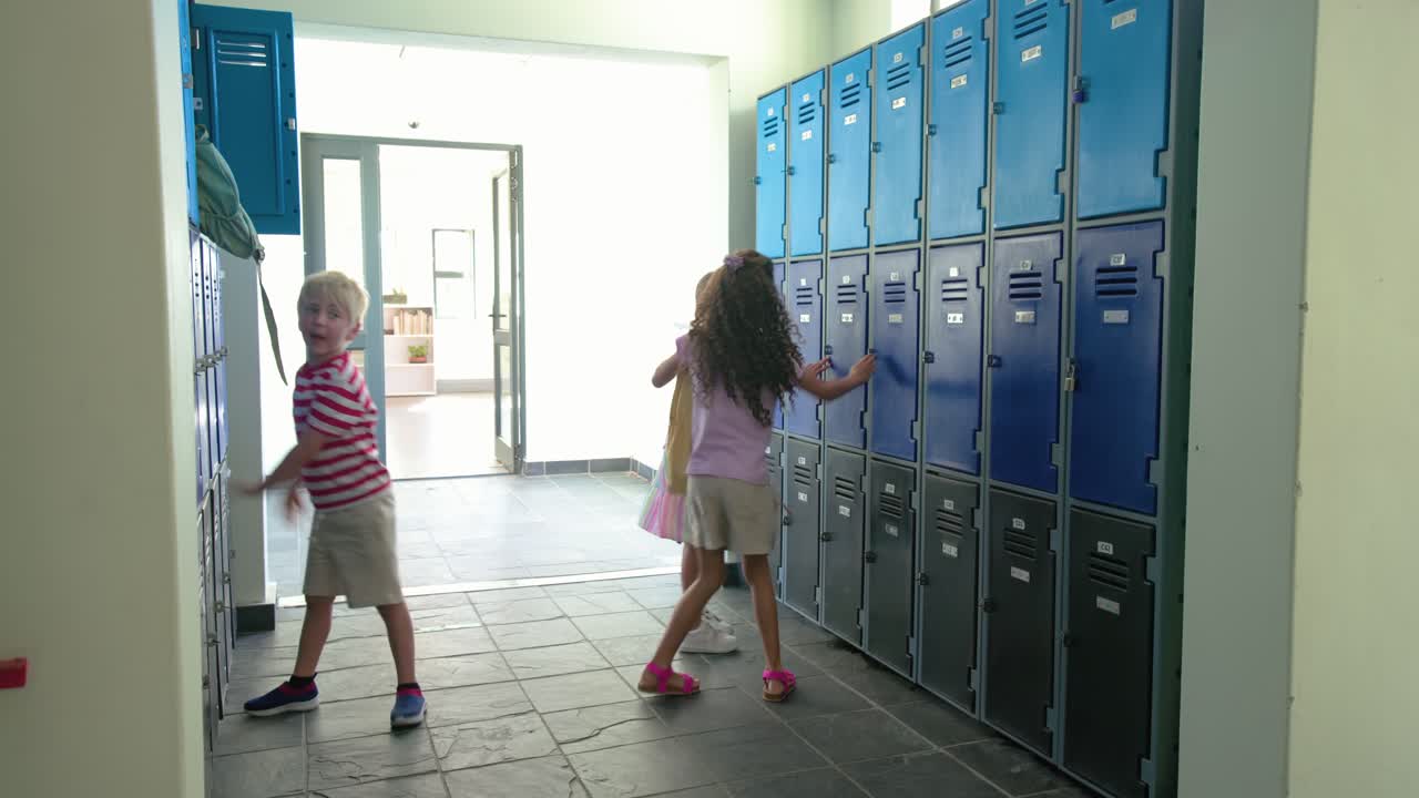 Three children entering school door, opening blue lockers, grabbing backpacks, descending stairwell