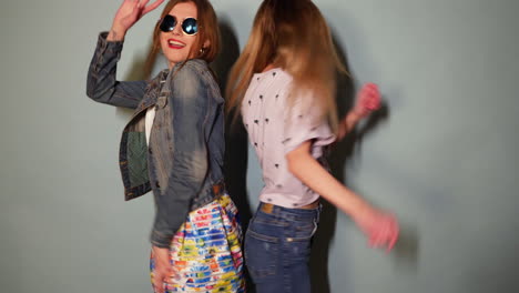 two girls dancing in trendy outfits