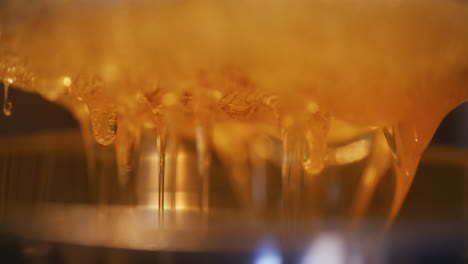 close-up of drops of thick golden honey