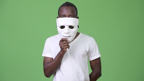 young african man with white mask