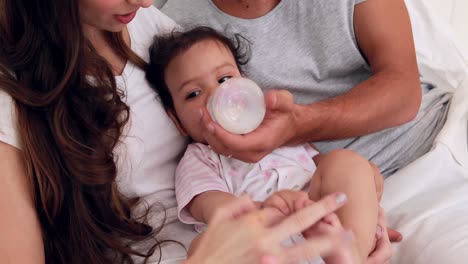 loving parents feeding their baby