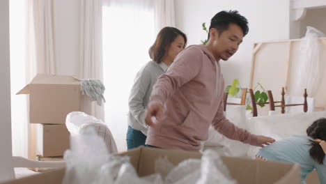 happy-asian-family-moving-into-new-home-owners-with-children-helping-parents-move-into-house-carrying-boxes-enjoying-teamwork-together-with-kids-real-estate-property-investment-4k-footage