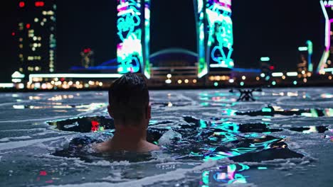 man ice swimming in night city
