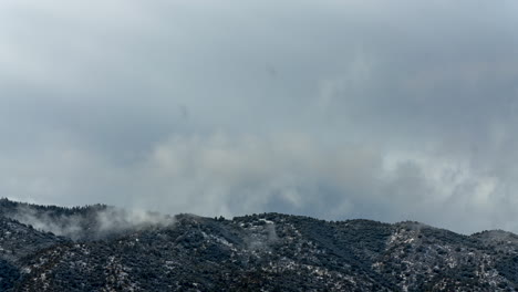 Dynamic-winter-cloudscape-above-the-mountains-cased-by-an-updraft-effecting-forming-clouds---time-lapse