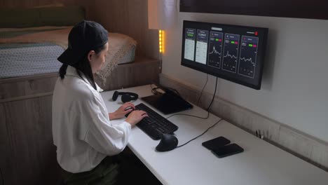 serious ethnic female trader analyzing cryptocurrency market statistics