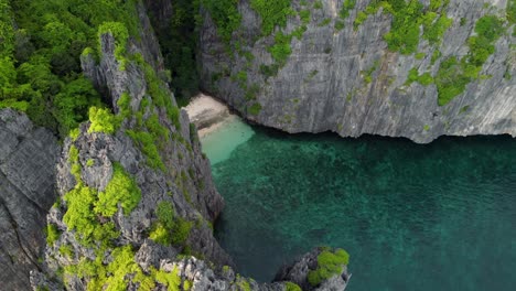 private cove with little sandy beach, ko phi phi le - maya bay island cliffs- krabi province thailand