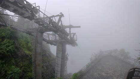 Cable-car-to-the-top-of-famous-holy-sacred-Tianmen-mountains-covered-in-early-morning-fog-and-mist,-Zhangjiajie,-China