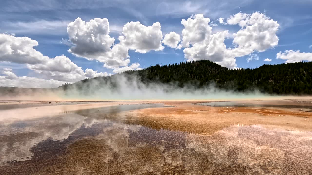 4K Grand Prismatic Spring in Yellowstone National Park, USA. Low angle static cam view of colorful rainbow colors of steam rising from the earth's surface