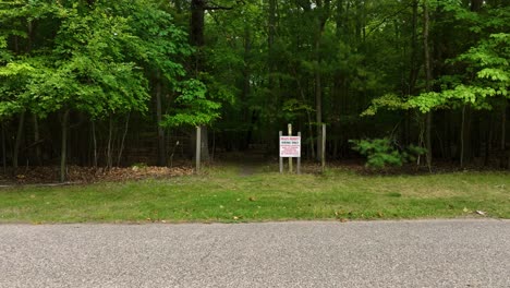 dolly motion, pulling back away from a trail sign