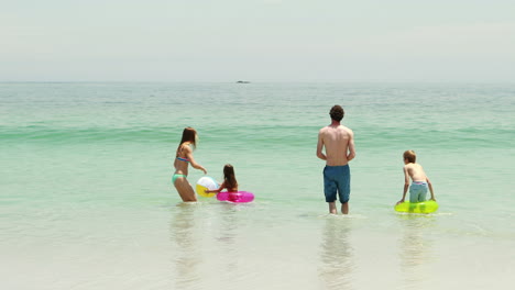 happy family playing in water