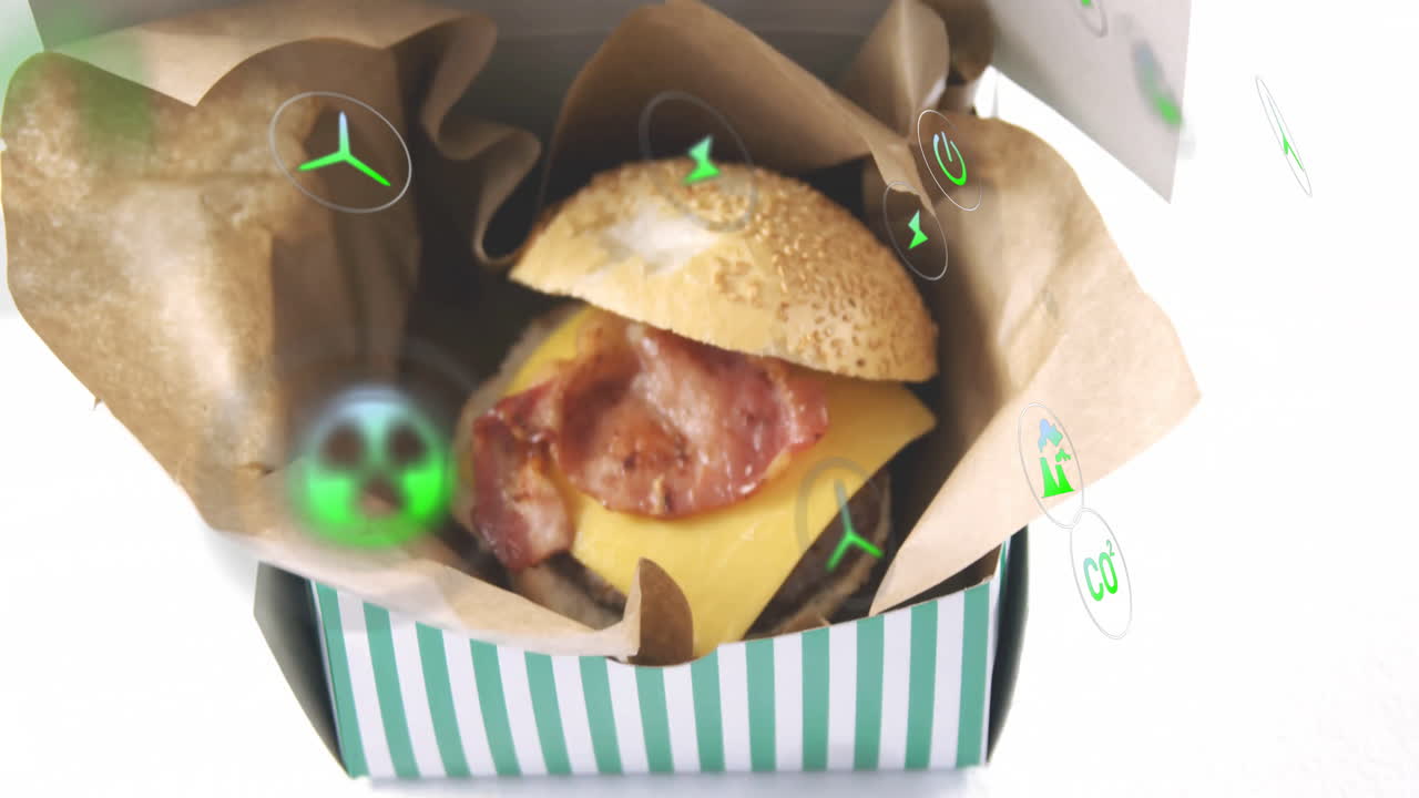 Cheeseburger with bacon in striped box, surrounded by digital icons animation