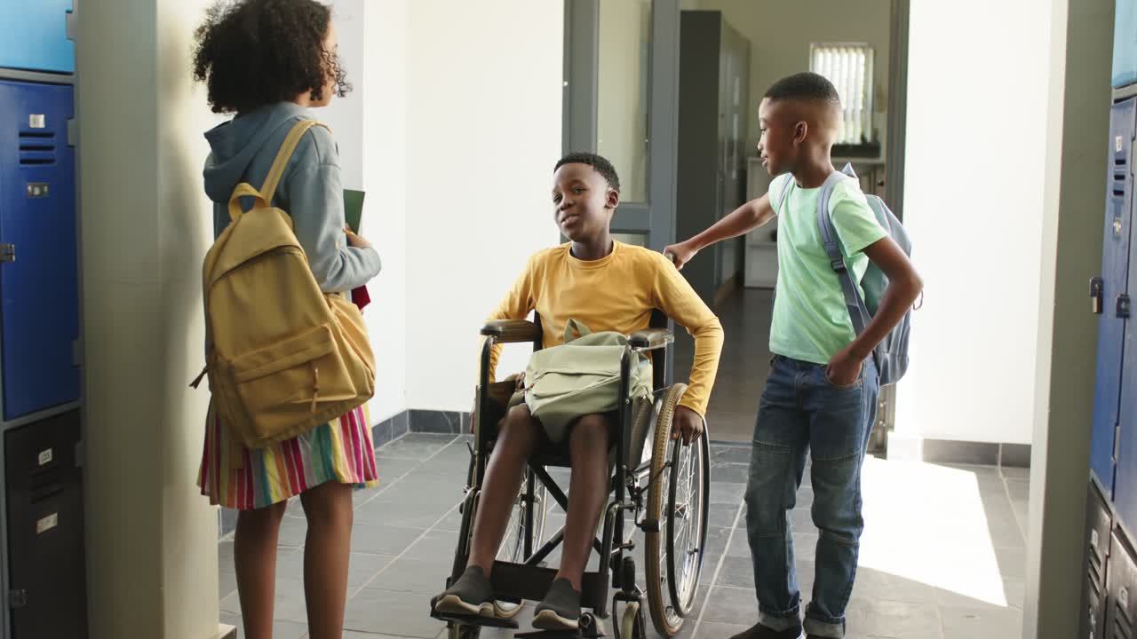 African American teens talking at lockers after bell, wheelchair boy turning, friends holding books