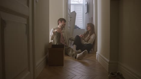 couple sitting in hallway during move