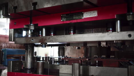 camera following a big hydraulic car part press while working in a automated production line