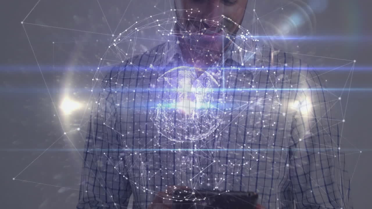 man holding tablet indoors, exploring glowing animated technology network sphere for design