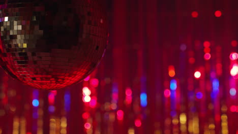 Close-Up-Of-Revolving-Mirrorball-In-Night-Club-Or-Disco-With-Flashing-Strobe-Lighting-And-Sparkling-Lights-In-Background