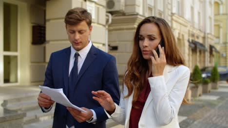 successful business couple working together outside.