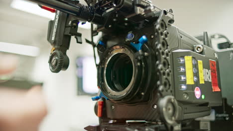 Camera-technician,-focus-puller-or-assistant-camera-removes-a-PL-Mount-lens-from-a-professional-cinema-camera,-removes-the-LPL-to-PL-adapter,-and-then-mounts-a-high-end-LPL-large-format-spherical-lens