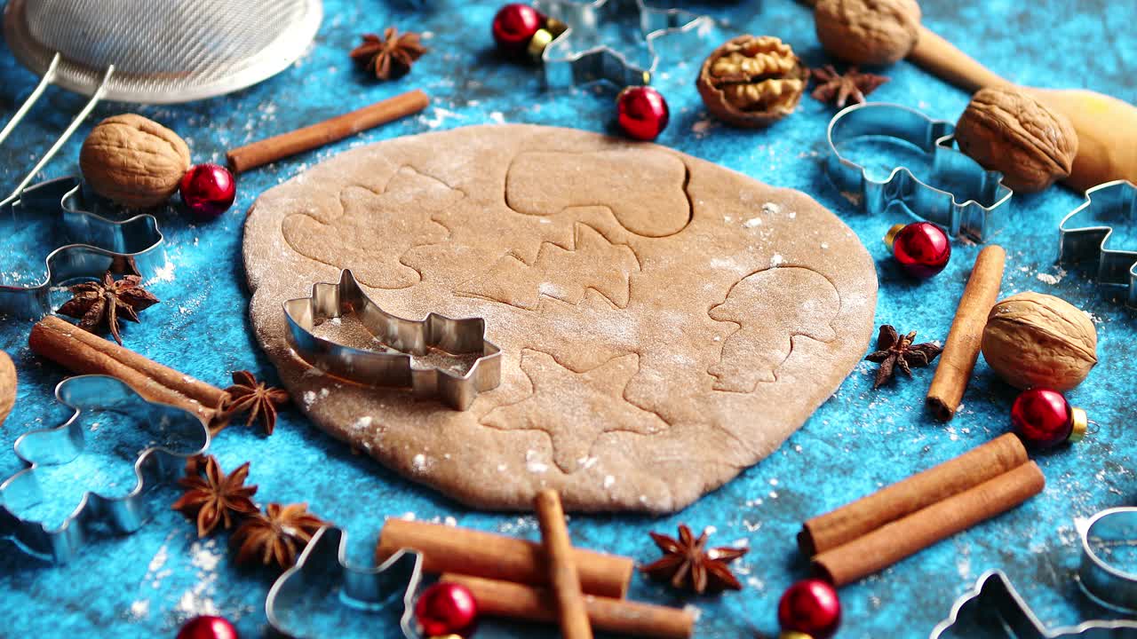 Christmas baking concept  Gingerbread dough with different cutter shapes