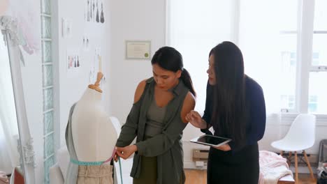 fashion designers using tablet while measuring dress makers model 4k