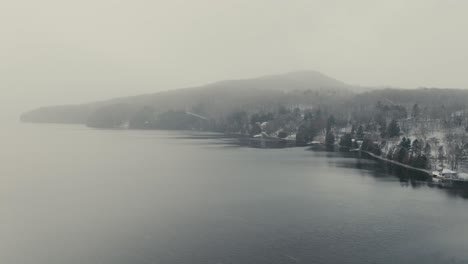 the appalachian mountains on the shores of lake massawippi near manoir hovey hotel during cold winter in quebec, canada