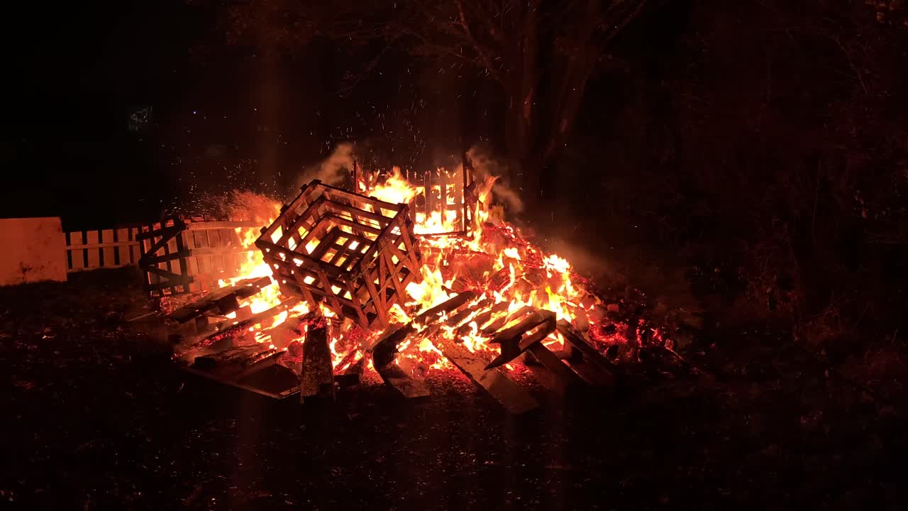 Hot bright blazing bonfire burning glowing wooden falling crate inferno