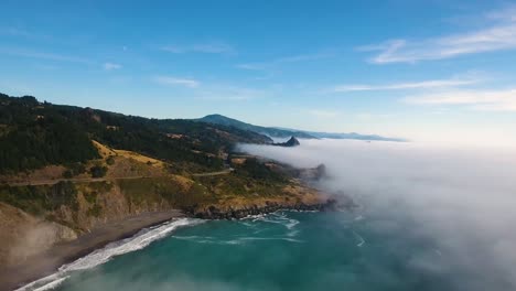 aerial: slow push in on a foggy oregon coastline