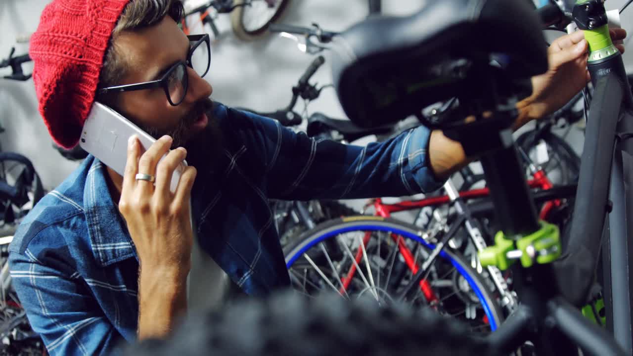 mecánico hablando por teléfono móvil en el taller
