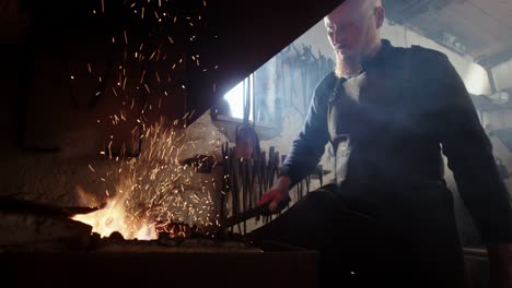 blacksmith heating up iron in his forge