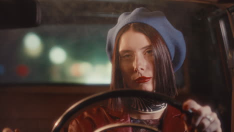 beautiful female driver smoking during night ride in vintage car