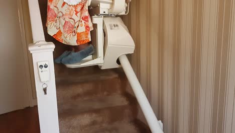elderly woman, of african ethnicity, using a residential stair lift
