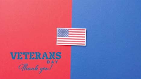 Animation-of-veterans-day-text-over-flag-of-usa-on-red-and-blue-background