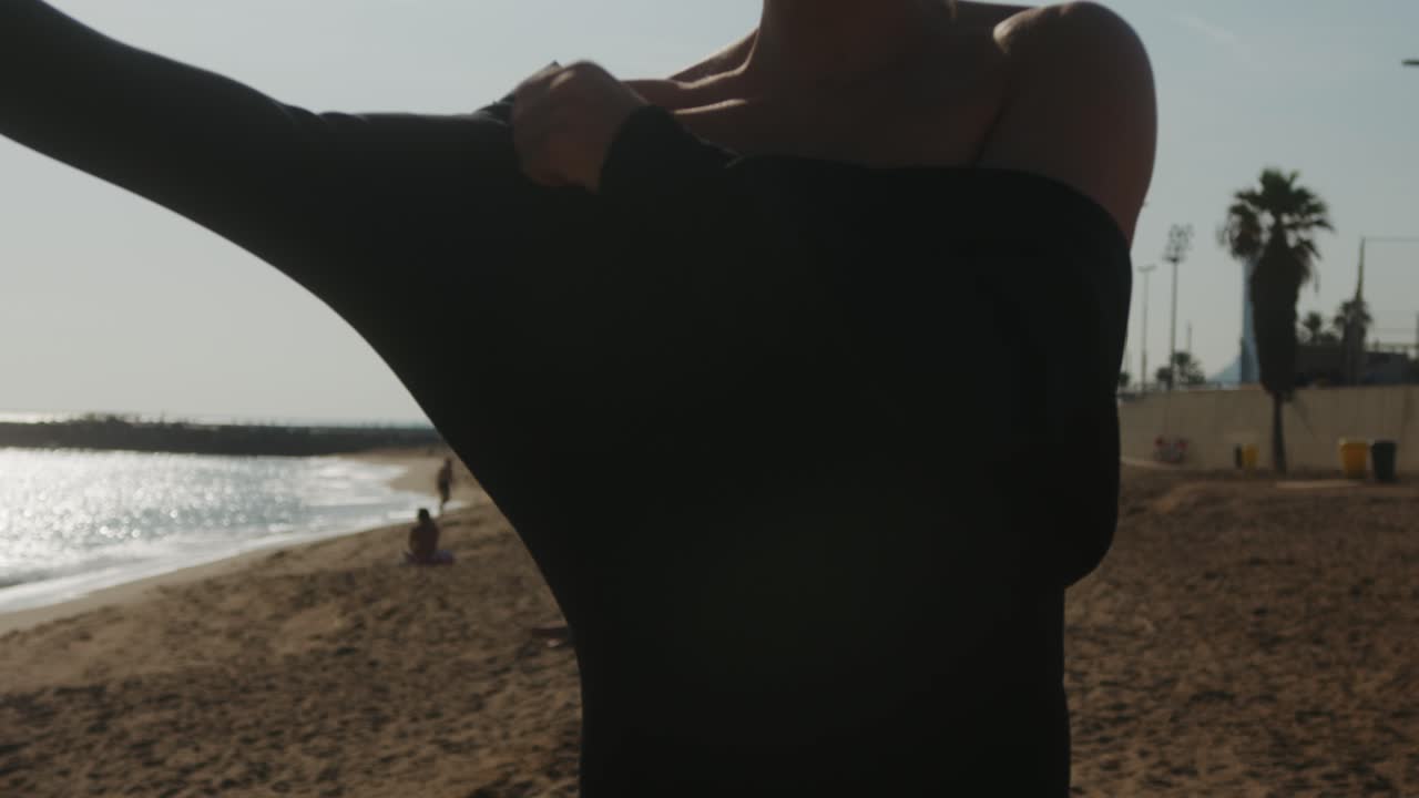 Surfer man walking to the beach at sunset preparing for surfing training and search for waves in Barcelona, spain, water, ocean exercise in sea with board, athletic male holiday or travel in vacation