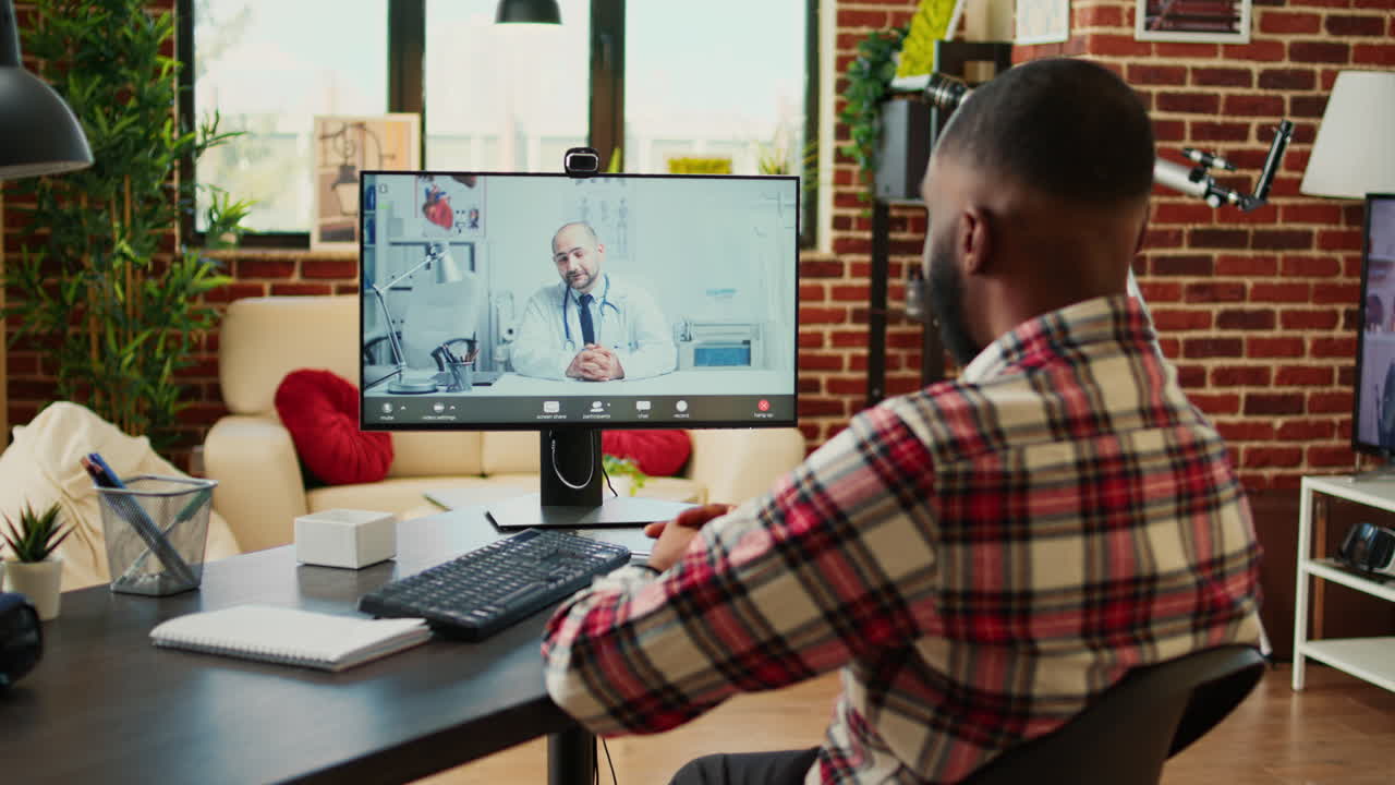 Man on Video Call with Doctor in Home Office