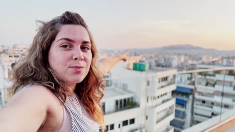 charming vlogger woman capturing selfie with athens view