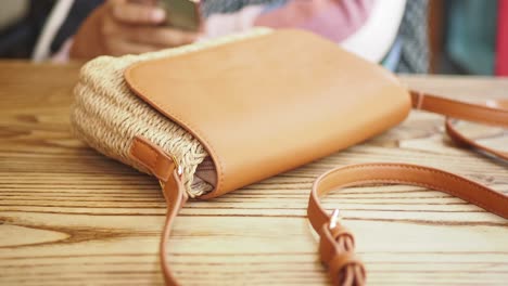 closeup of a brown woven bag with a leather strap