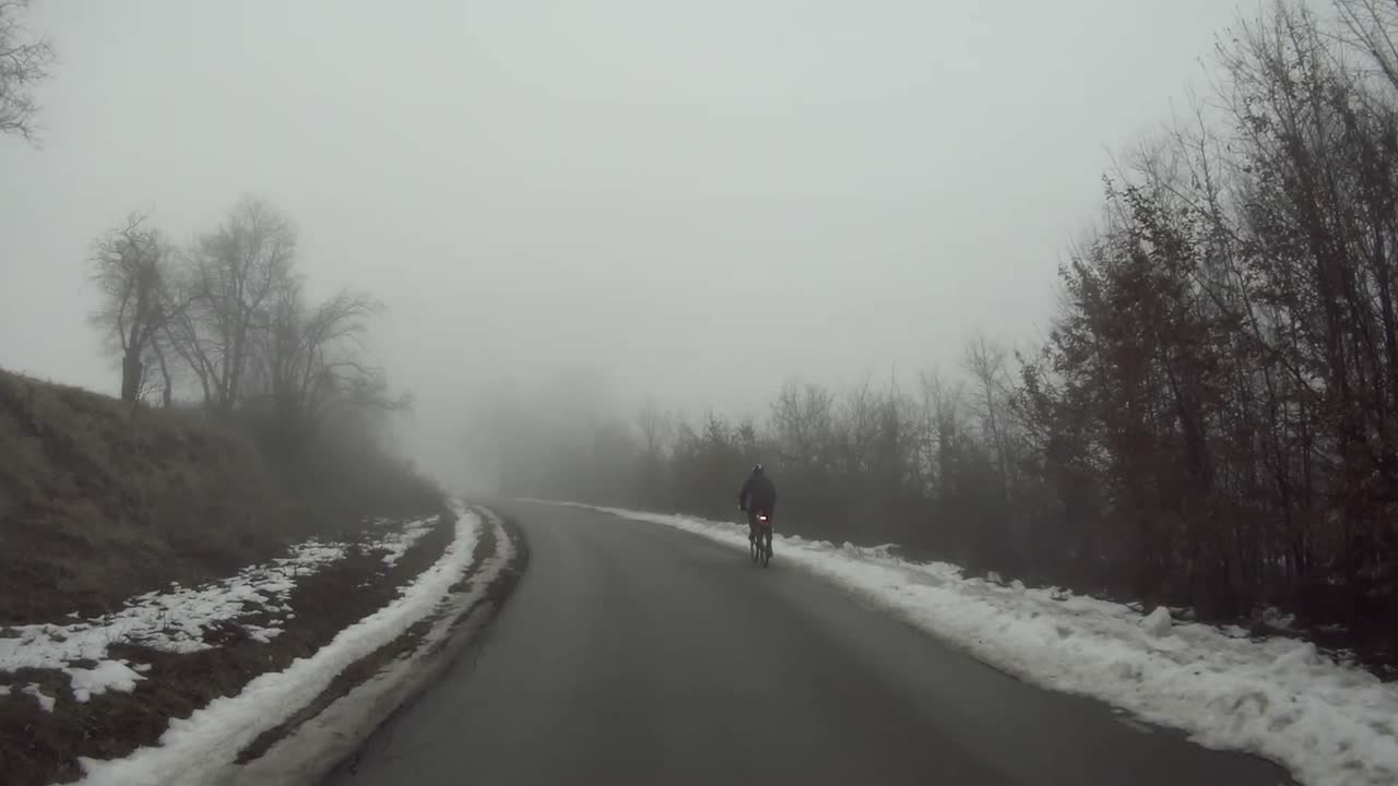 A car moves along a mountain road. Misty January Day. The camera moves forward. Video background.