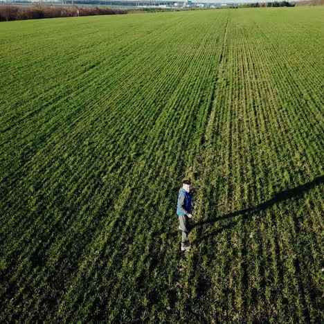 boy is running on the green field of wheat. happy kid running on beautiful field square video