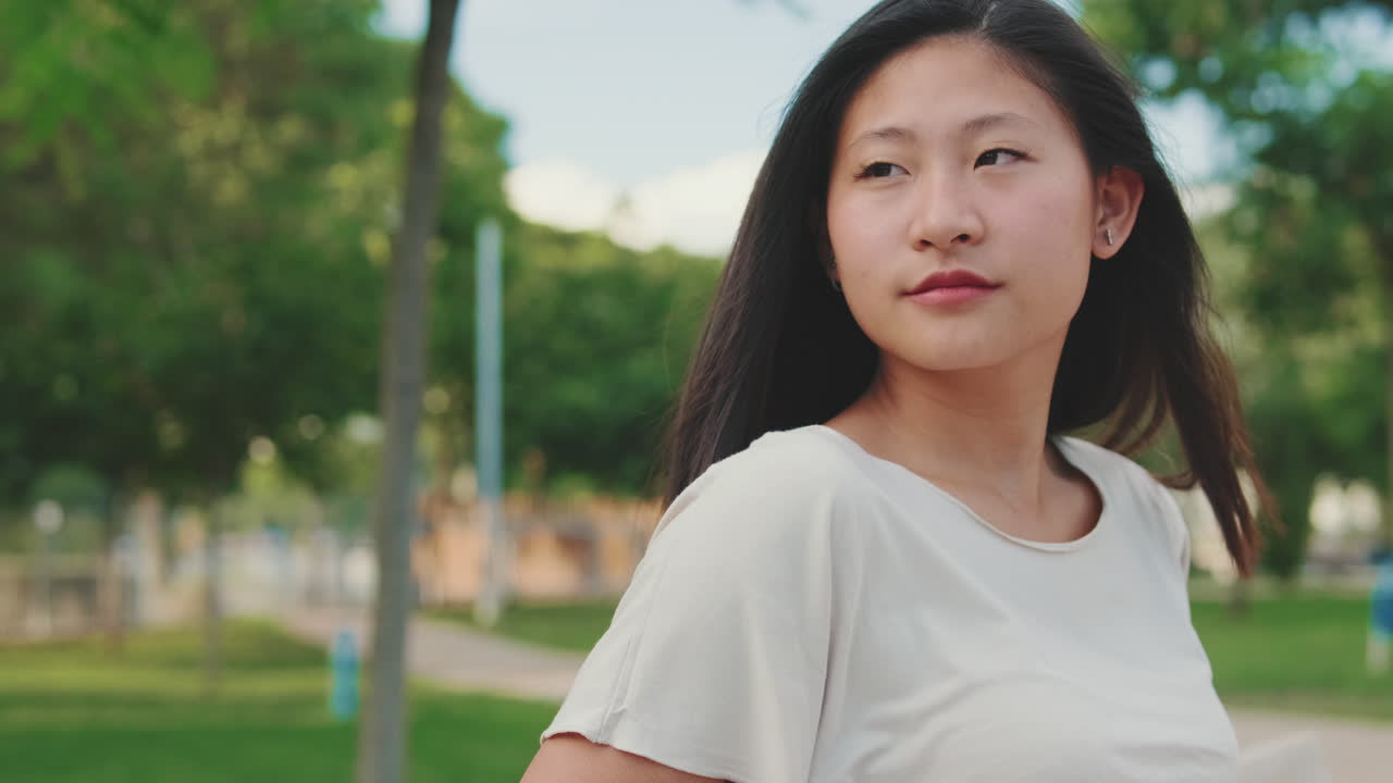 Portrait of an Asian woman in a park