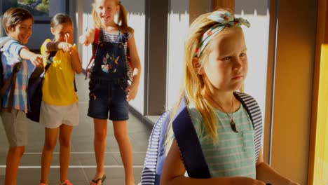 Schoolkids-bullying-a-sad-girl-in-hallway-of-elementary-school-4k