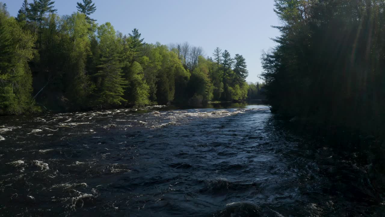 Flying upstream over the Gatineau River as it flows through vast pine forests
