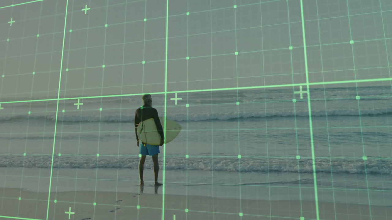 Adult man holding surfboard on sandy beach, overlaying green grid illustrating technology concept