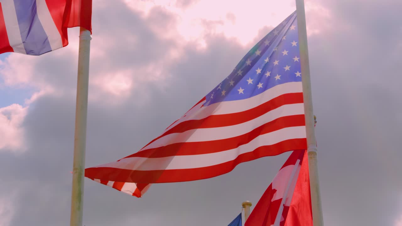 Three Flags Waving in the Wind: American, Canadian, and French Flags