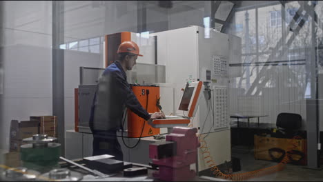 factory worker operating cnc machine