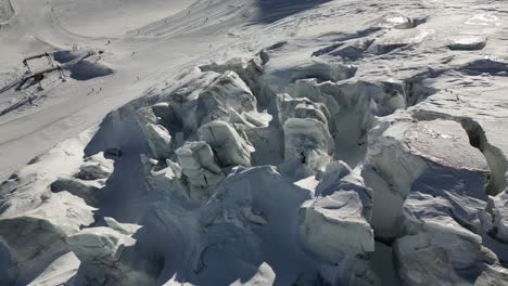 vista aérea: glaciar en los alpes y pista de esquí al fondo, paisaje invernal