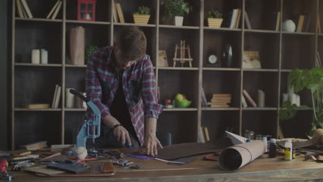 concentrated craftsman cutting leather material ar workplace