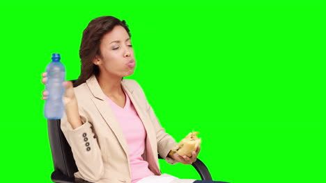 businesswoman eating sandwich for lunch