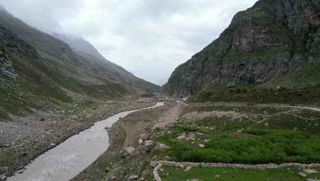 aerial landscape of river flowing through a mountain valley in himachal pradesh of india on cloudy day